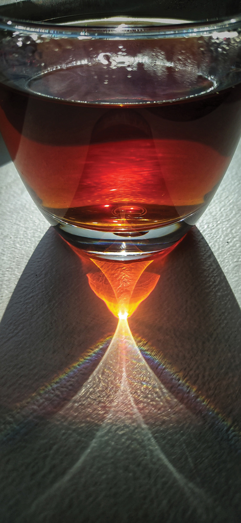 The curved surface of a glass of tea 