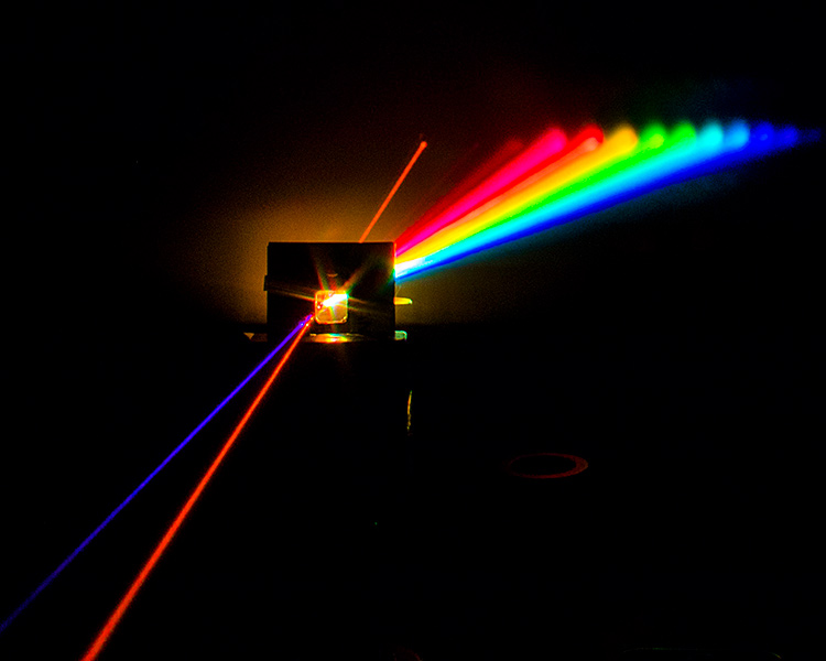 A multiplexing stream: The beams from three laser pointers of different wavelengths pass through a tank of water, and exit into a single water stream