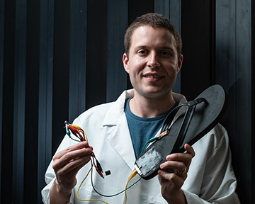 man holding electrically connected flip-flop