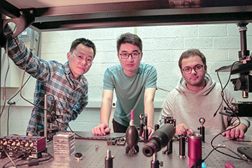 three men in lab